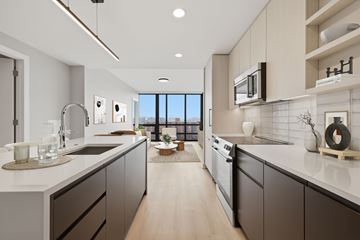 Washington apartment for rent - A modern kitchen with dark brown cabinets and a white countertop.