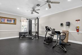 Woodbridge apartment for rent - A home gym with a treadmill, exercise bike, and weights.