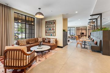 Charlotte apartment for rent - A living room with a brown chair and a brown sofa.