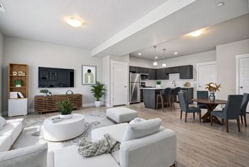Millcreek apartment for rent - A modern living room with a white sofa set and a wooden entertainment center.