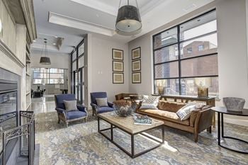 A living room with couches and chairs and a fireplace