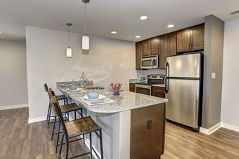 A kitchen with stainless steel appliances and a granite counter top