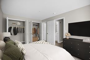 Lorton apartment for rent - A bedroom with a large bed and a black dresser.
