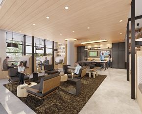 Washington apartment for rent - A modern office space with people working at desks and a large screen on the wall.