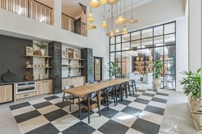 Tampa apartment for rent - a dining room with a long wooden table and chairs in front of a large window  at La Unión, Tampa, 33605