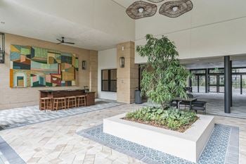 A lobby with a garden and a painting on the wall