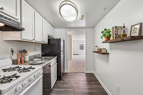Rockville apartment for rent - A kitchen with white cabinets and a black refrigerator.