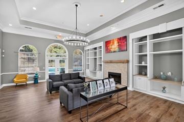 Canton apartment for rent - A living room with a grey couch and a fireplace.