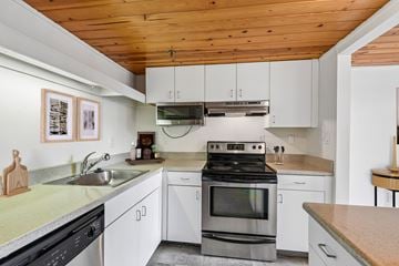 Baltimore apartment for rent - A modern kitchen with a stove top oven and a microwave above the stove.