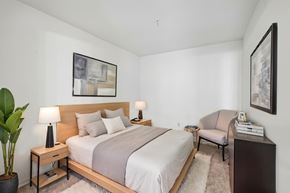 Rockville apartment for rent - A bedroom with a large bed and a chair.