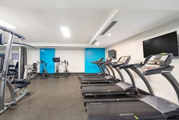 A gym with treadmills and exercise equipment.