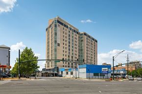 Silver Spring apartment for rent - A large building with a blue Sport store in front.