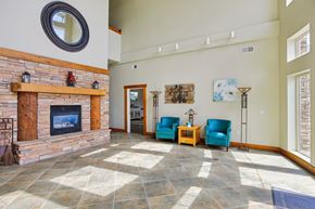 Hideout apartment for rent - A living room with a fireplace and blue chairs.