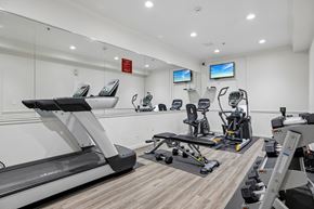 Hideout apartment for rent - A gym with treadmills, exercise bikes, and other equipment.