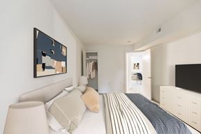 Rockville apartment for rent - A bedroom with a bed, a lamp, and a painting on the wall at The Fields of Rockville, Rockville, 20850