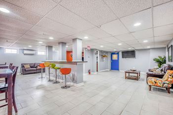 A spacious living room with a kitchen area in the background