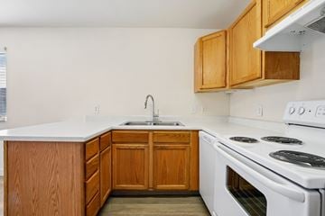 Hideout apartment for rent - A kitchen with a white stove top oven and wooden cabinets.