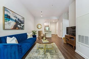 A living room with a blue couch and a coffee table