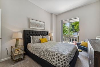 A bedroom with a bed and a large window