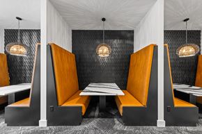 Charlotte apartment for rent - a dining room with orange booths and tables  at South and Hollis, North Carolina