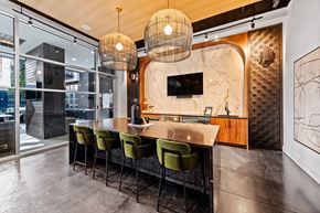 Charlotte apartment for rent - a kitchen with a marble counter top and green chairs at South and Hollis, North Carolina