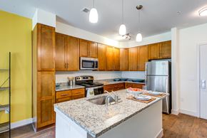 Nottingham apartment for rent - a kitchen with wooden cabinets and granite counter tops
