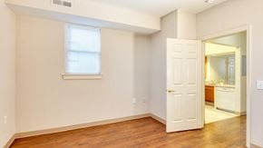 Frederick apartment for rent - a bedroom with a door and a bathroom with a mirror at North Market South Carroll, Frederick, MD 21701