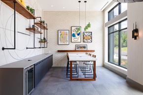 Washington apartment for rent - a kitchen with a long table and a large window at The Chase at Bryant Street, Washington