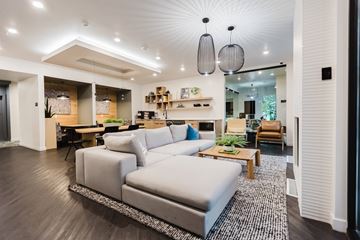 Salt Lake City apartment for rent - A modern living room with a grey sofa and a wooden coffee table.