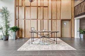 Washington apartment for rent - a dining room with a table and chairs in front of a wood wall at Coda at Bryant Street, Washington, DC