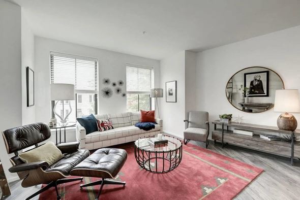 Washington apartment for rent - a living room filled with furniture and a large round mirror at Reed Row, Washington, DC