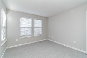 Lorton apartment for rent - an empty bedroom with two windows and white carpeting at The Fields at Lorton Station, Lorton, VA