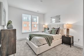 Wilmington apartment for rent - a bedroom with a large bed and two windows at the Riverwalk, Wilmington