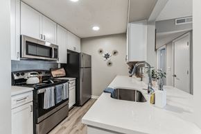 Cary apartment for rent - a kitchen with white cabinets and stainless steel appliances at Brampton Moors, Cary, 27513