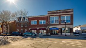 Frederick apartment for rent - a brick building with cars parked in front of it at North Market South Carroll, Maryland
