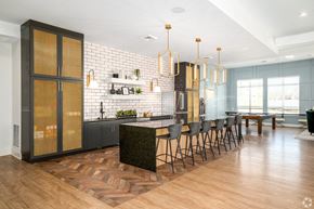Bowie apartment for rent - a large kitchen with an island and chairs in front of a dining room at Fairmont at South Lake, Bowie, MD