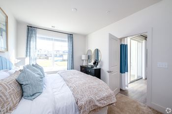 A bedroom with a large bed and a window