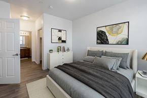 Midvale apartment for rent - A bedroom with a large bed and a painting on the wall.at Florentine Villas, Midvale Utah