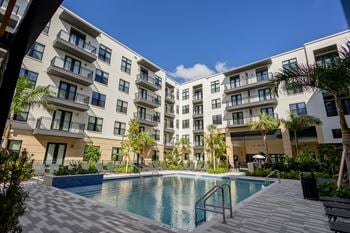 A swimming pool in front of an apartment building