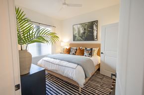 Tampa apartment for rent - a bedroom with a bed and a potted plant  at La Unión, Tampa, FL, 33605
