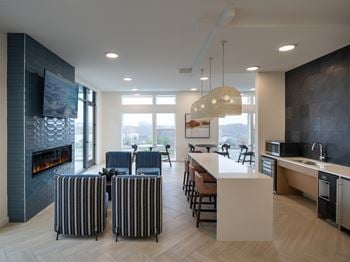 A modern kitchen with a fireplace and a dining area