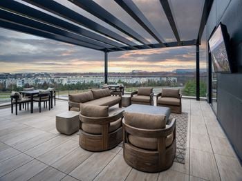 A modern outdoor seating area with a view of the city