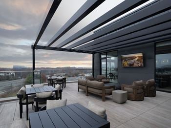 A modern outdoor seating area with a view of the city