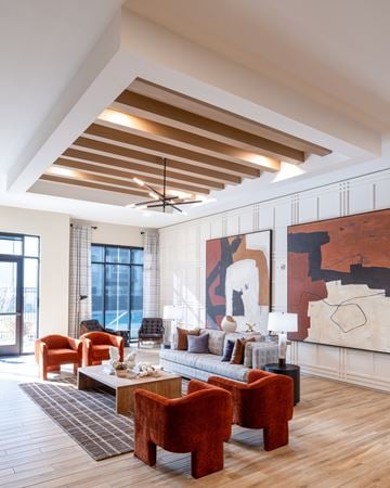 Chantilly apartment for rent - A living room with a large painting on the wall and a wooden floor.