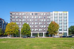 Washington apartment for rent - A large building with a grassy area in front of it.