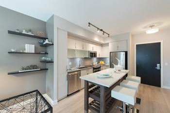 A modern kitchen with a dining table and chairs.