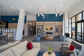 A modern living room with a fireplace and a large window