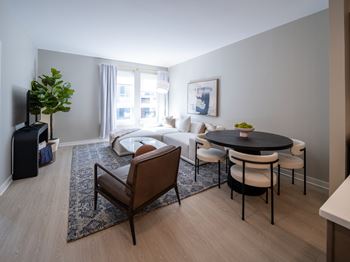 A living room with a black table and white couch