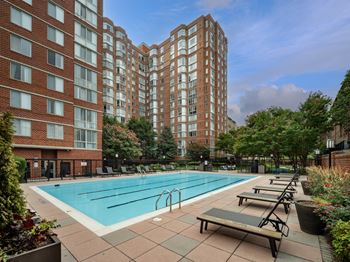 A swimming pool in front of an apartment building