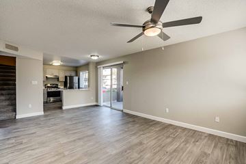 Phoenix apartment for rent - A spacious living room with a ceiling fan and lighting fixtures.